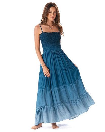 Woman wearing a blue maxi dress on a white background