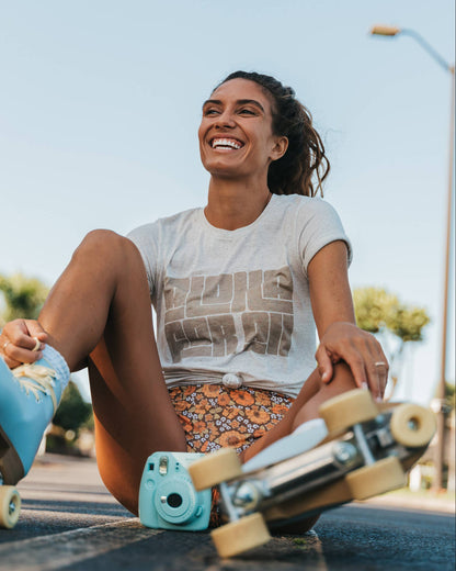 Woman wearing shirt that says "Aloha For All"